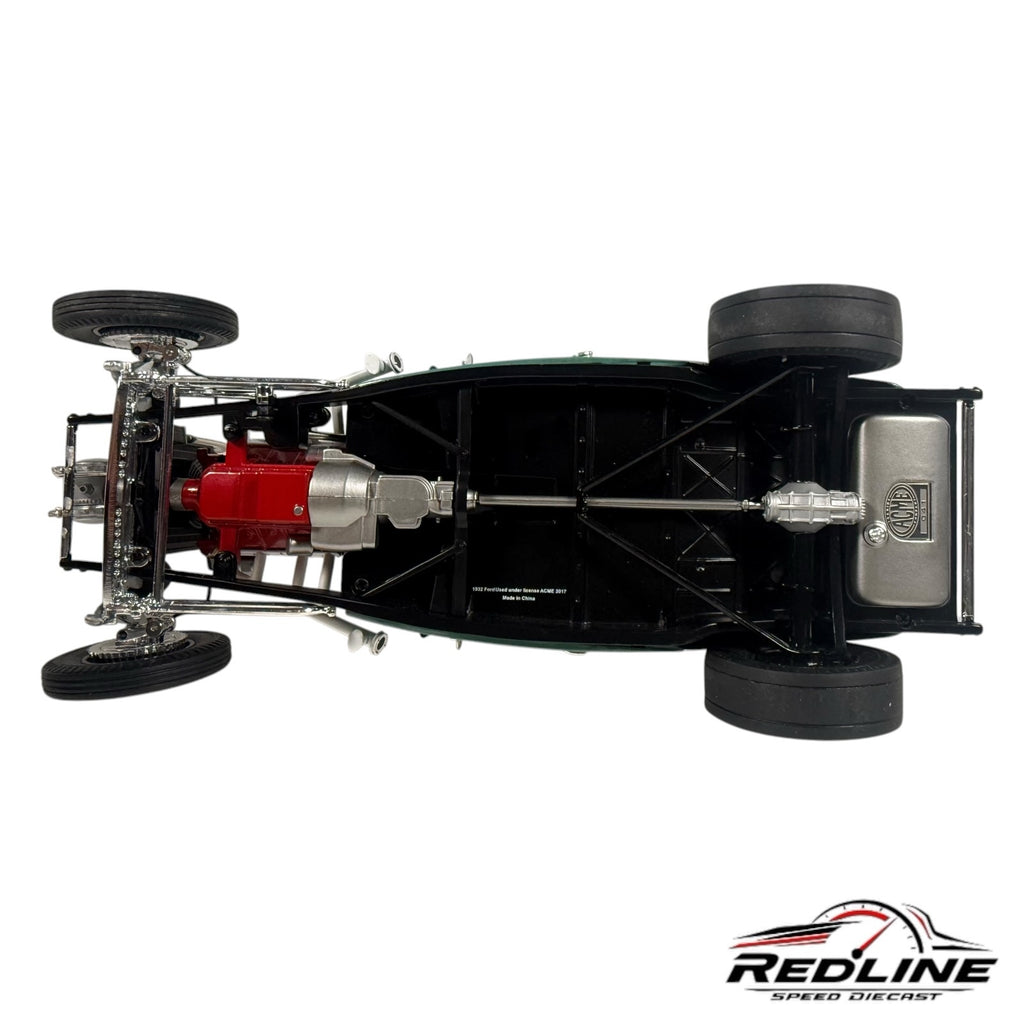 Underside view of a 1932 Ford hot rod diecast model showing the detailed chassis, red engine block, and fuel tank.