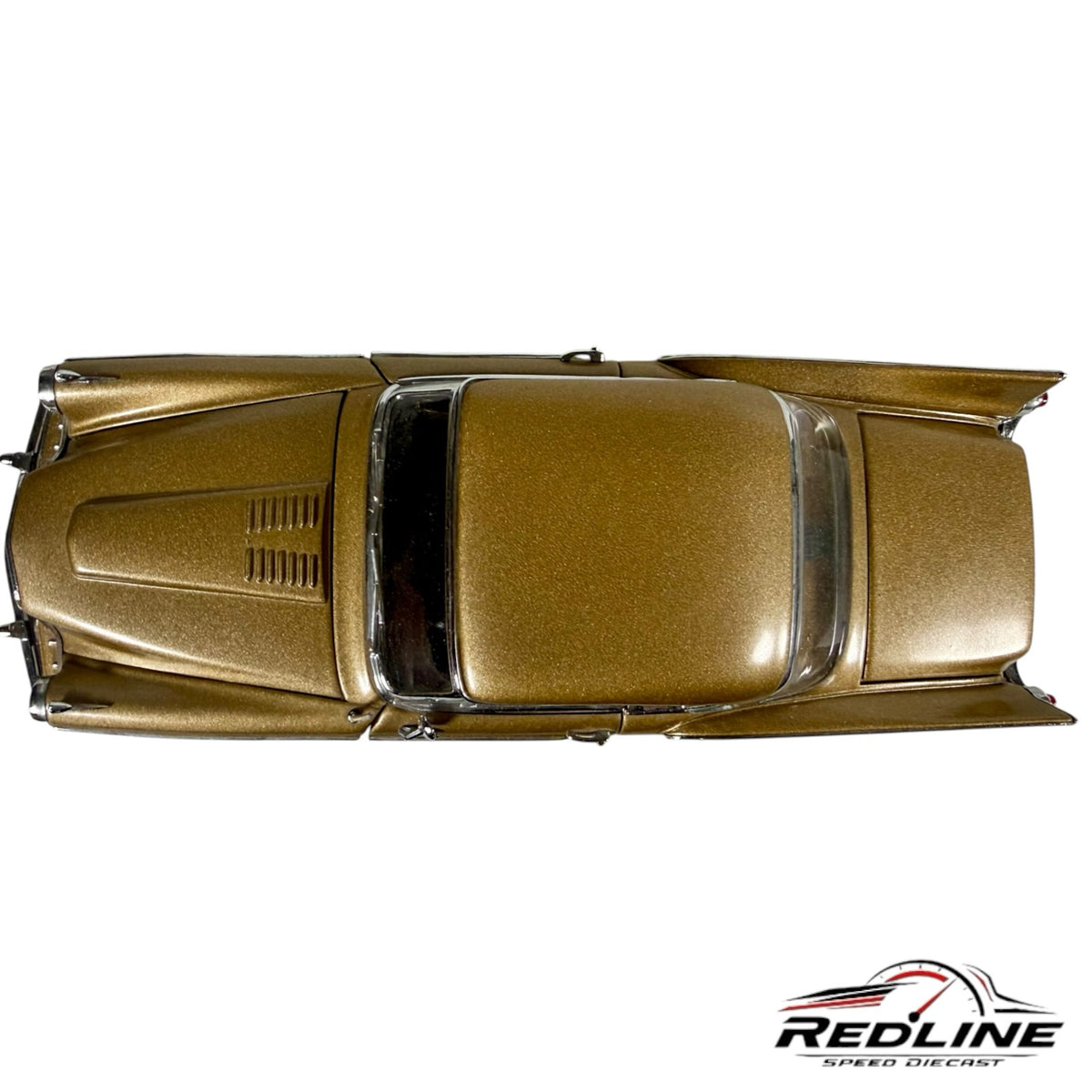 Redline Speed Diecast 1957 Studebaker Golden Hawk model car in metallic gold, viewed from a top-down perspective.
