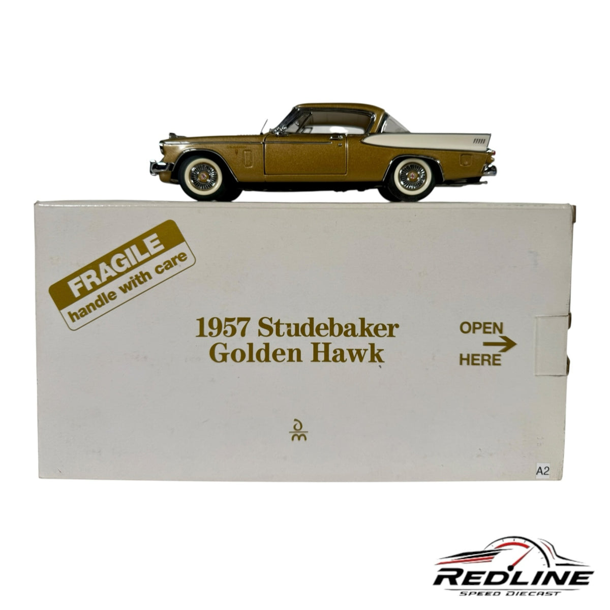Redline Speed Diecast 1957 Studebaker Golden Hawk model car in metallic gold displayed on its branded white box