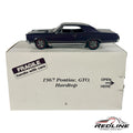 Redline Speed Diecast 1967 Pontiac GTO hardtop model car in dark purple metallic with red-line tires on its display box