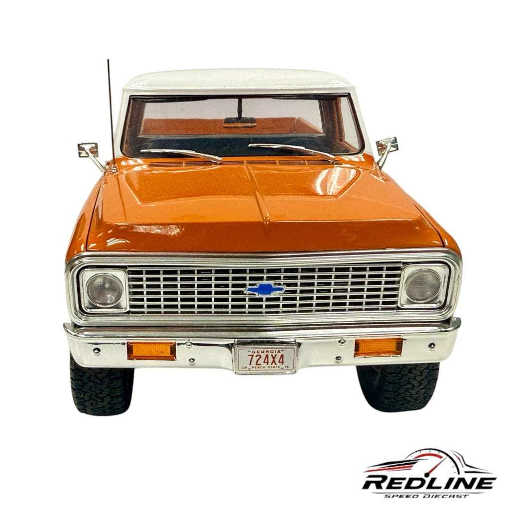 Redline Speed Diecast 1972 Chevrolet K-10 4x4 model in orange and white with chrome grille and front bumper