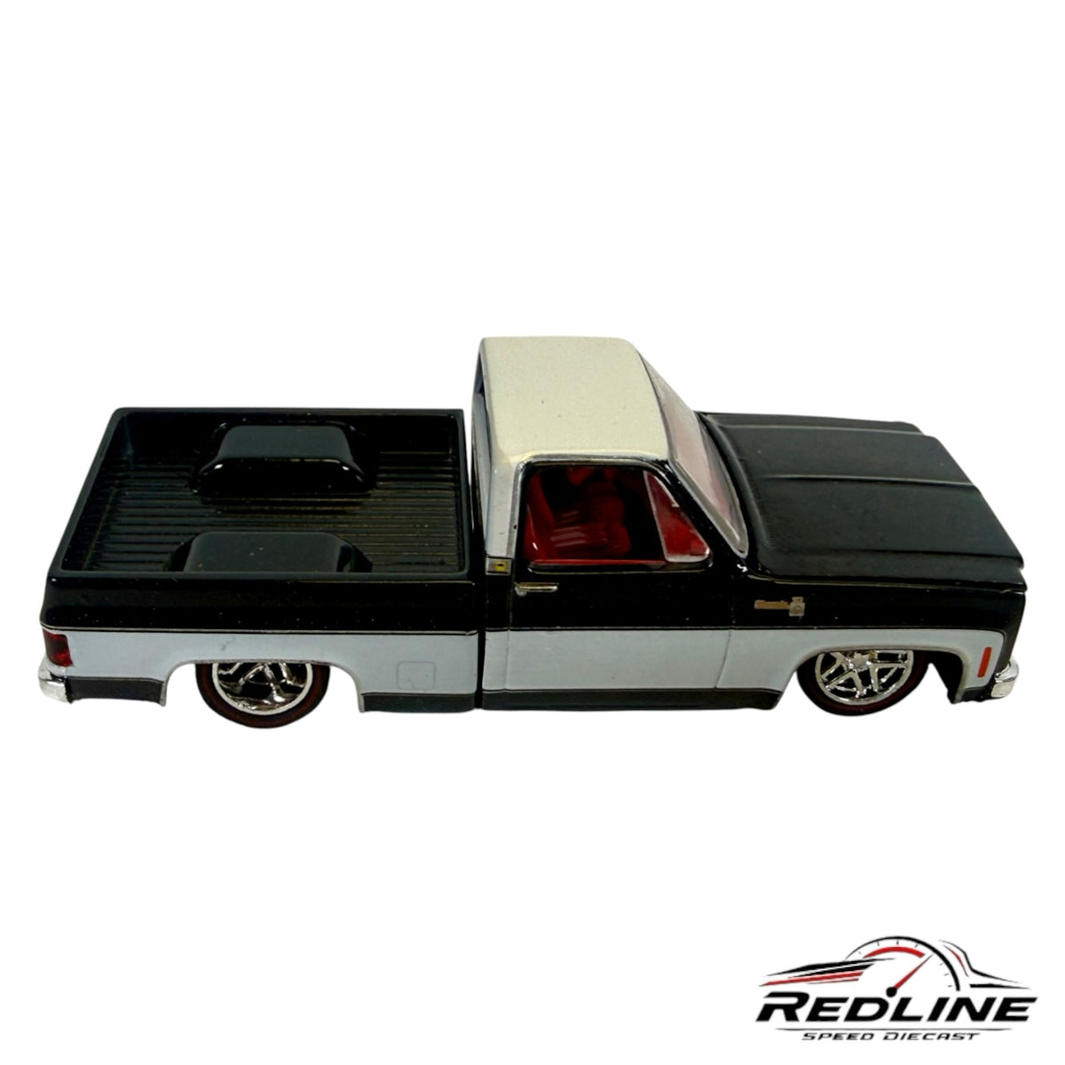 Redline Speed Diecast 1973 Chevrolet C10 truck model in black and silver with a lowered stance and red interior.