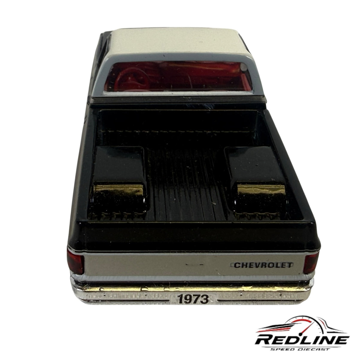 Redline Speed Diecast 1973 Chevrolet C10 pickup truck model in black and silver with a red interior, rear view.