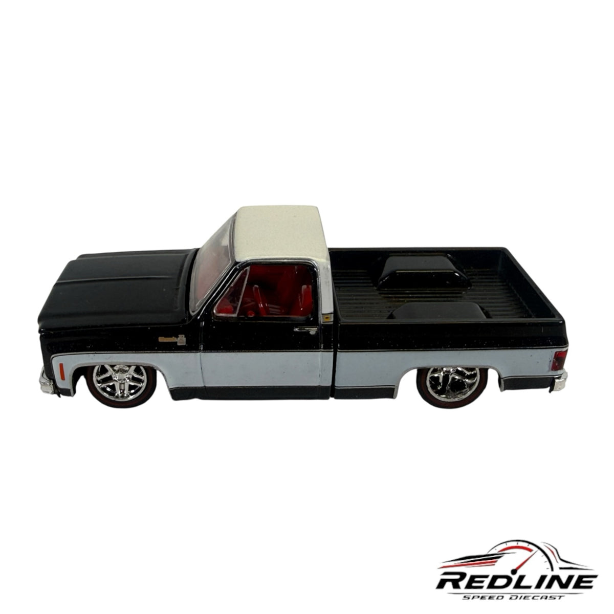 Redline Speed Diecast 1973 Chevrolet C10 pickup truck model in black and silver with a red interior and custom wheels.