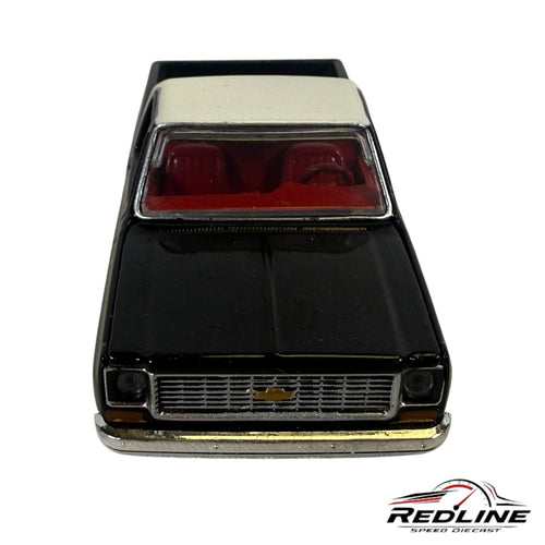 Redline Speed Diecast 1973 Chevrolet C10 truck model in black and silver with a detailed red interior