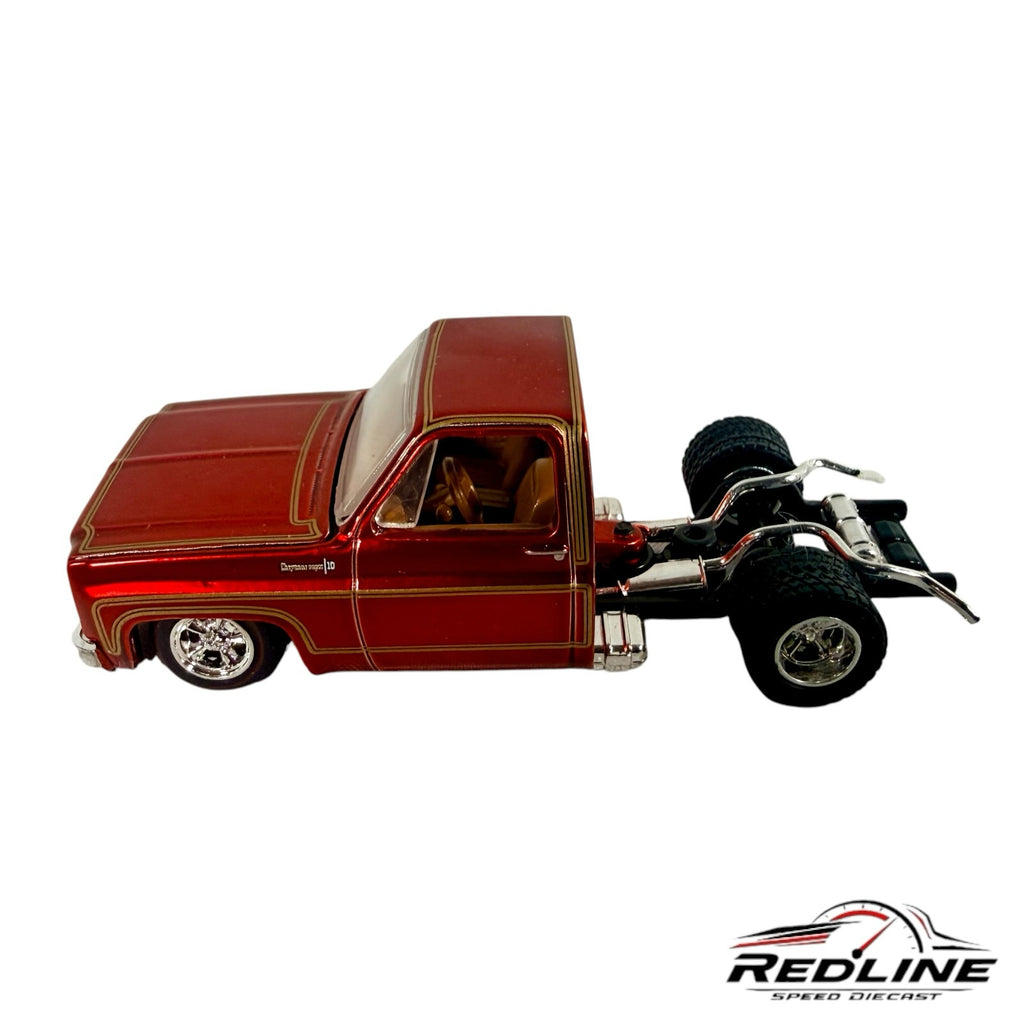 Redline Speed Diecast 1973 Chevrolet Cheyenne custom truck model in deep red with gold pinstriping and tan interior.