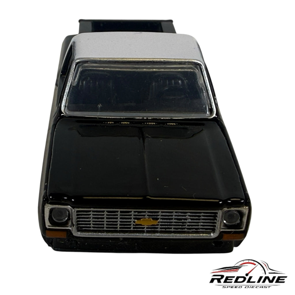 Redline Speed Diecast 1973 Chevrolet Cheyenne 10 model truck in black and silver with chrome grille front view