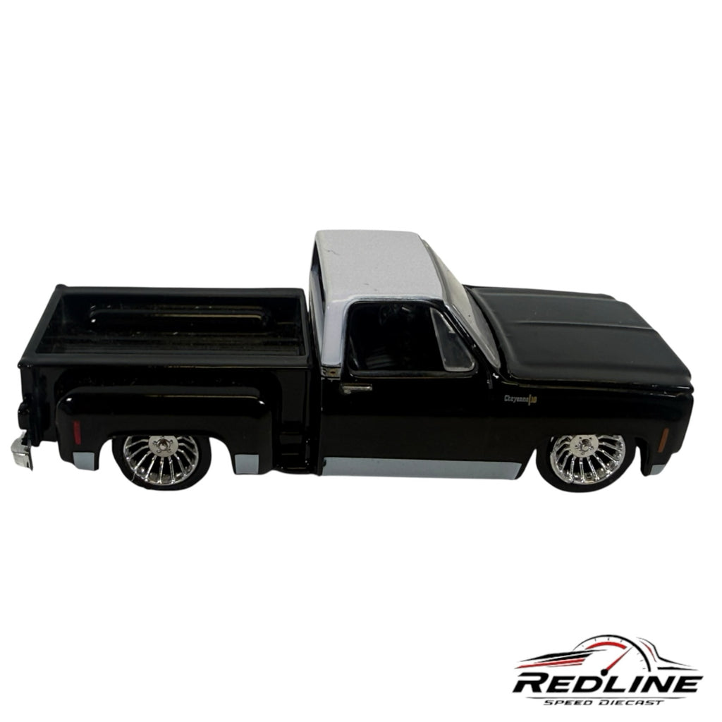 Redline Speed Diecast 1973 Chevrolet Cheyenne 10 truck model in black and silver with chrome custom wheels