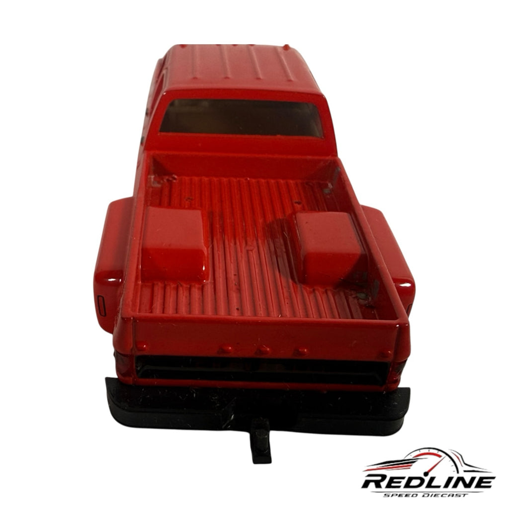 Redline Speed Diecast 1973 Chevrolet crew cab dually pickup truck model in glossy red, rear view showing truck bed