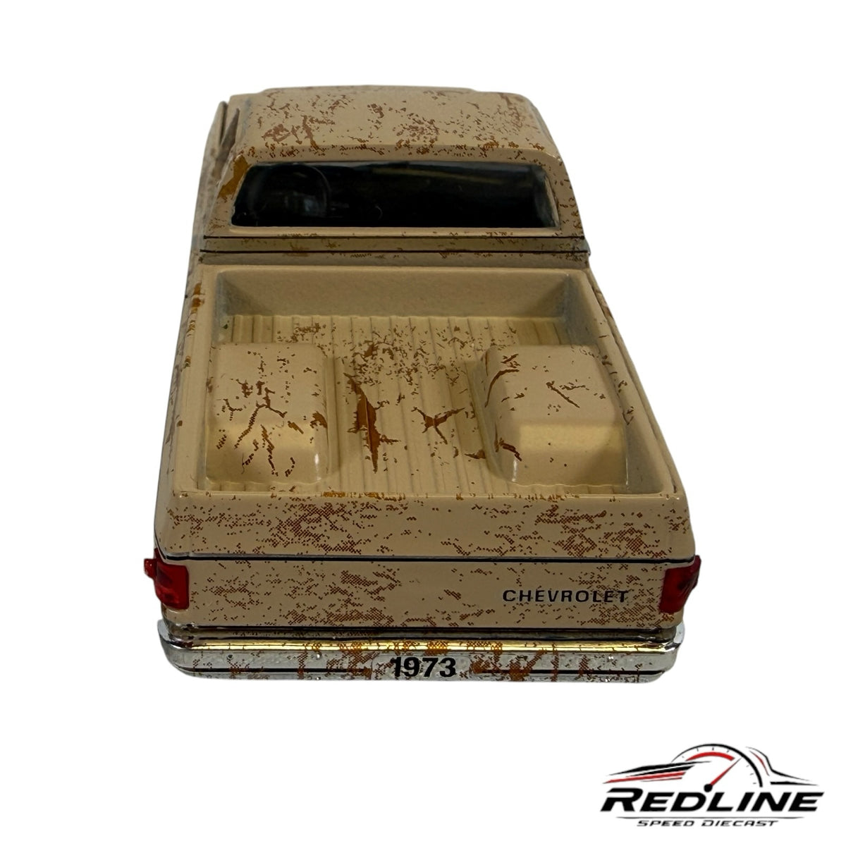 Redline Speed Diecast 1973 Chevrolet pickup model in weathered tan with a distressed finish and chrome bumper