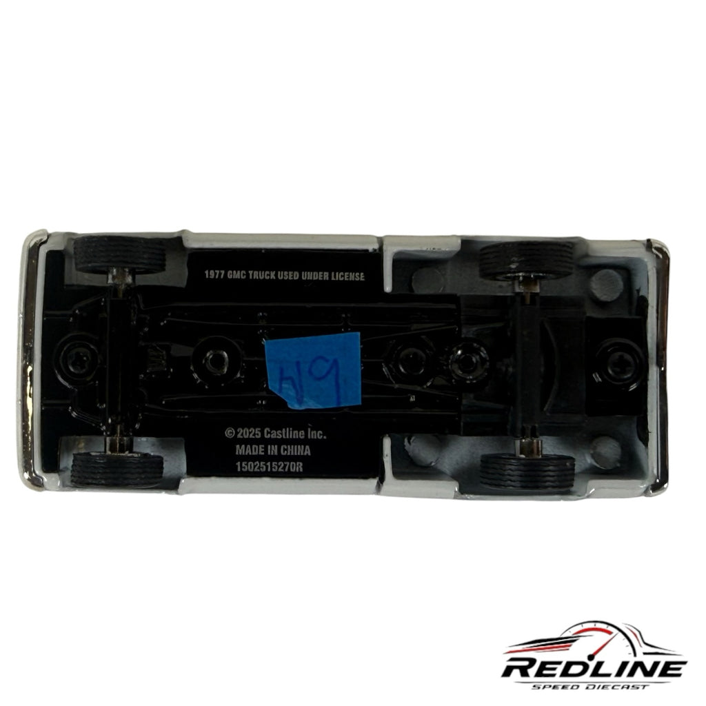 Underside view of a Redline Speed Diecast 1977 GMC Sierra Grande model truck showing chassis details and markings.