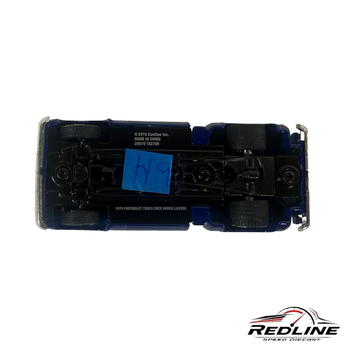 Underside view of a Redline Speed Diecast 1979 Chevrolet C10 pickup truck model showing chassis and wheel detail.