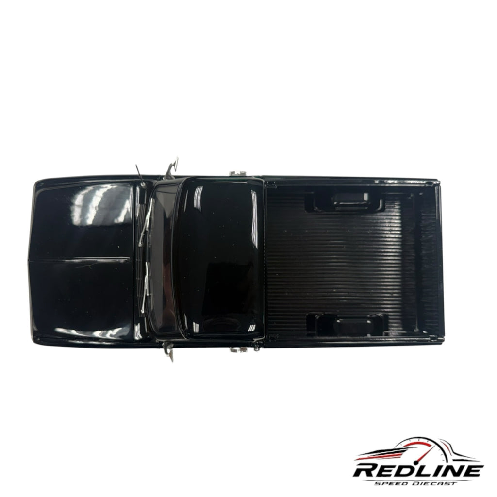 Redline Speed Diecast 1970 Chevrolet K-10 pickup truck model in glossy black, top-down view of the truck bed and cab.