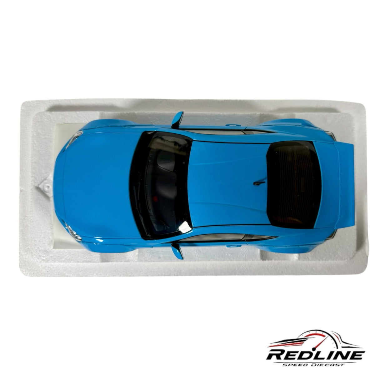 Redline Speed Diecast blue Rocket Bunny widebody sports car model in top-down view on white foam packaging