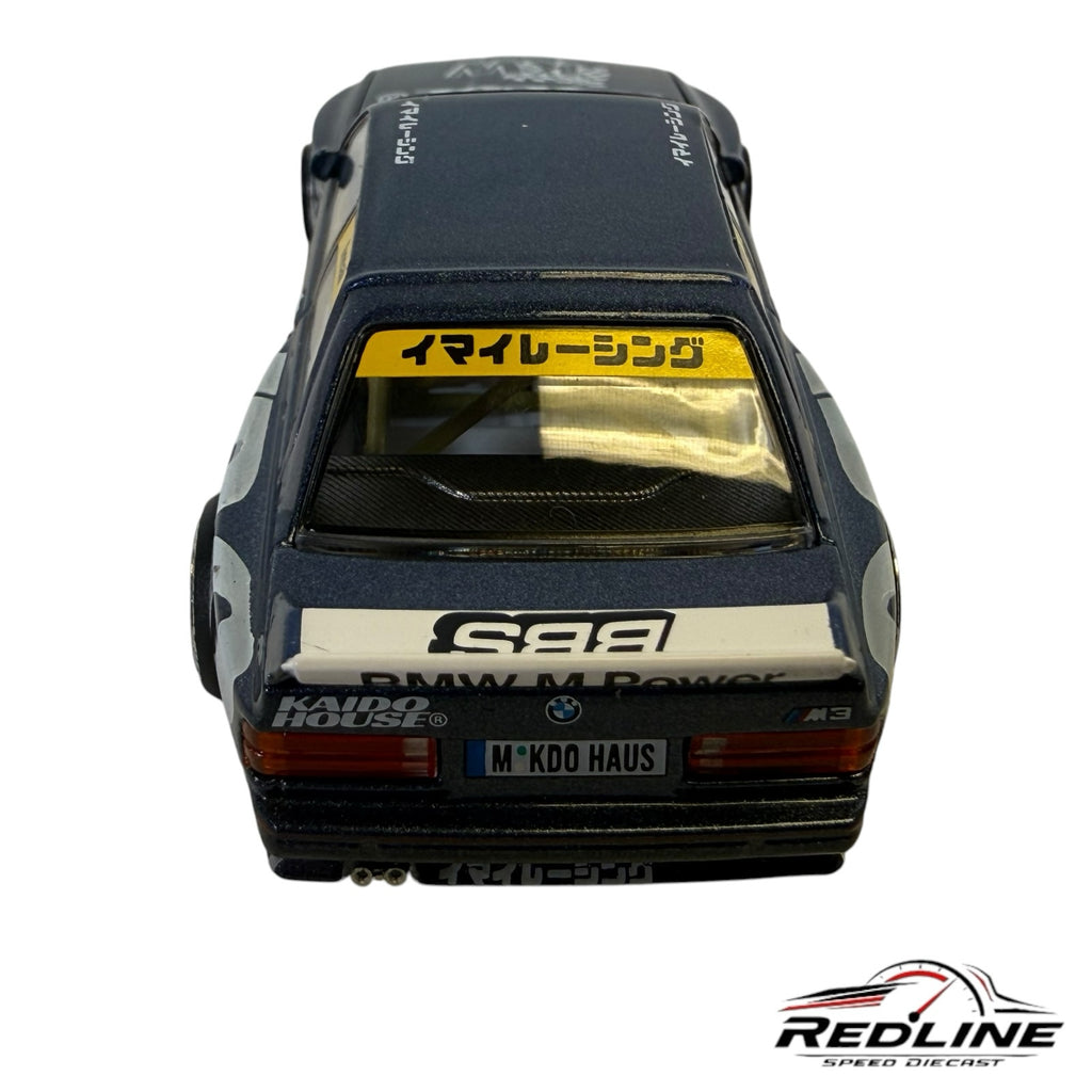 Redline Speed Diecast BMW M3 Kaido Works model car in metallic blue with racing decals and rear spoiler, rear view