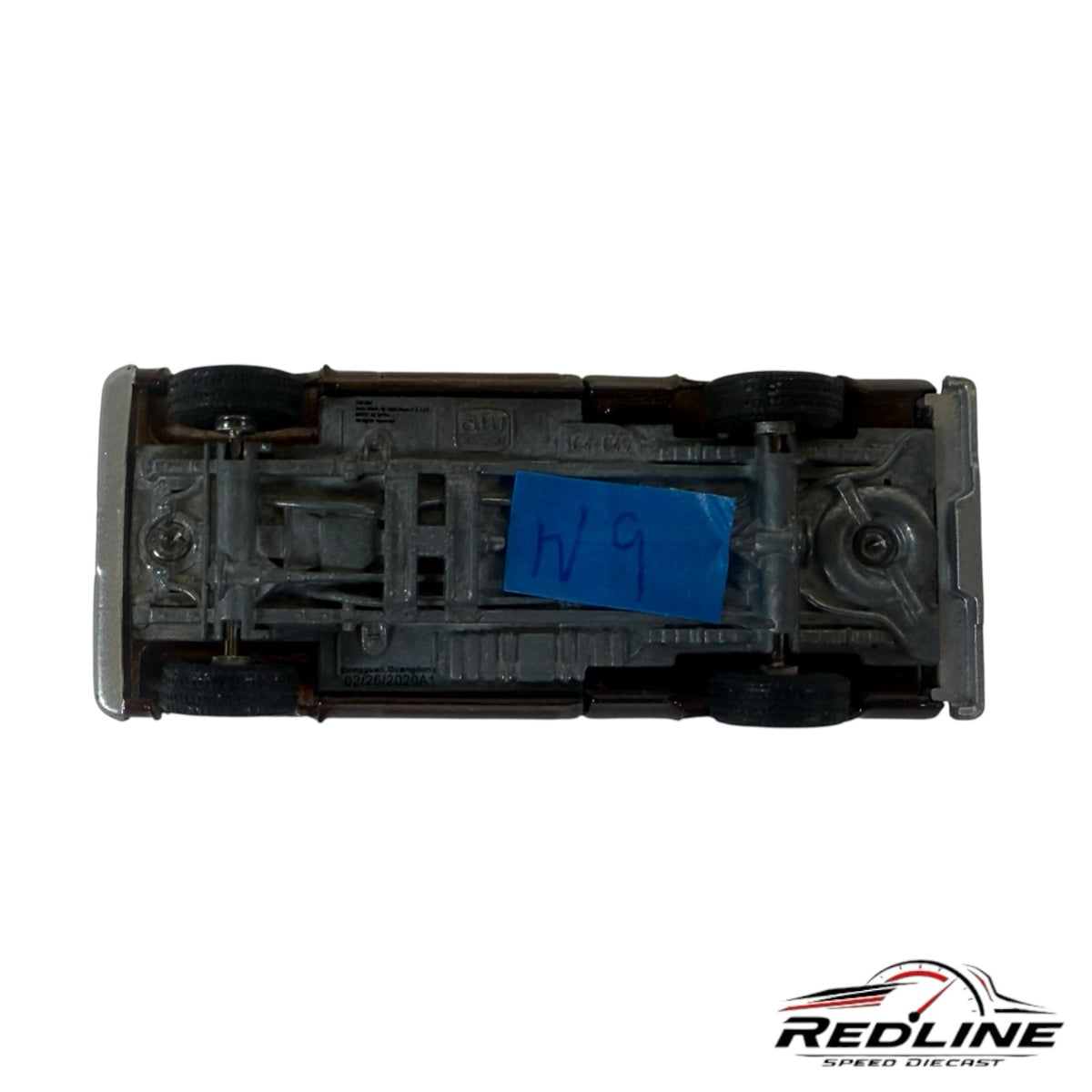 Underside view of a Redline Speed Diecast 1977 Chevrolet C10 pickup model showing chassis and wheel details