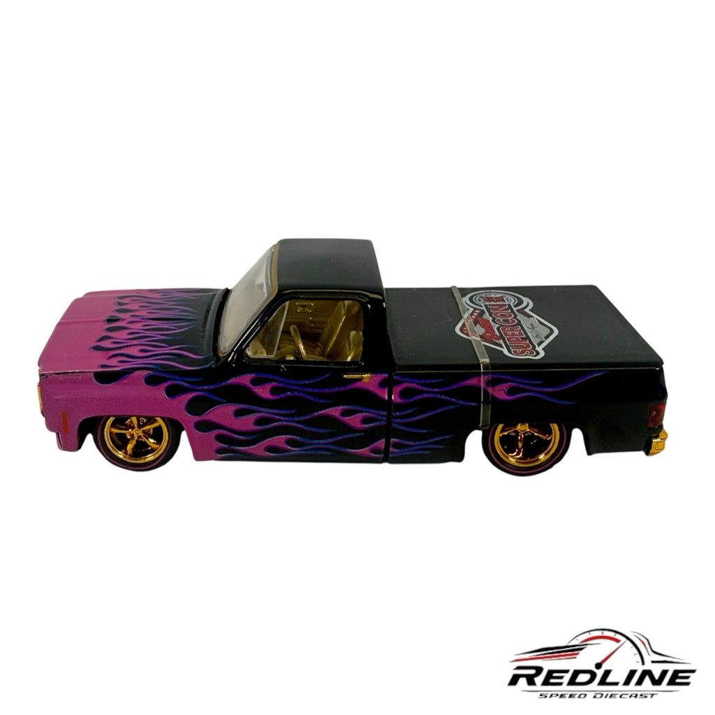 Redline Speed Diecast 1979 Chevrolet C10 custom pickup truck model with black and pink paint and purple flame graphics.