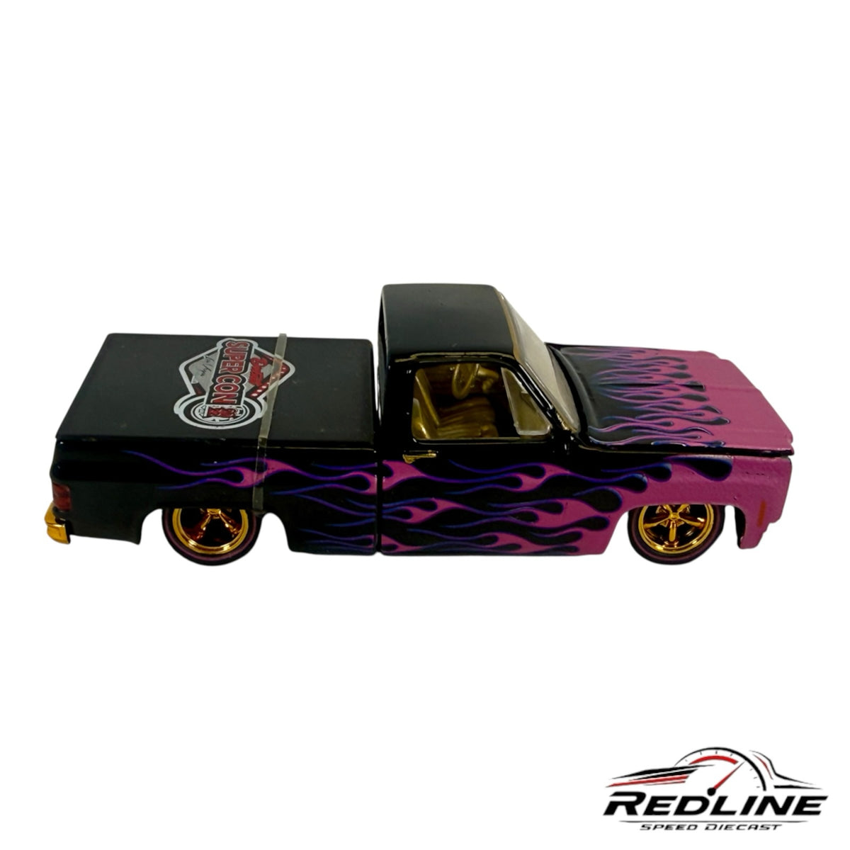 Redline Speed Diecast 1979 Chevrolet C10 custom pickup truck with black and pink paint, purple flames, and gold wheels.