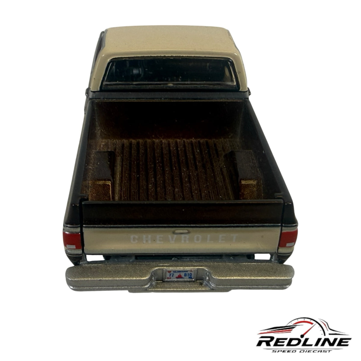 Rear view of a Redline Speed Diecast 1977 Chevrolet C10 pickup truck model in brown and cream with a detailed truck bed