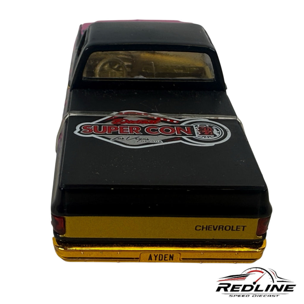 Redline Speed Diecast 1979 Chevrolet C10 pickup model with black paint, gold bumper, and Super Con Las Vegas bed graphic
