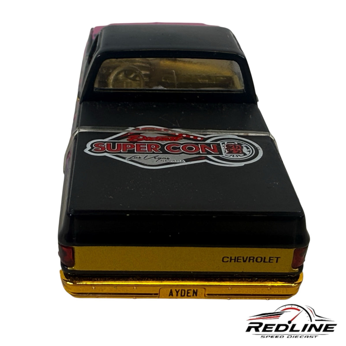 Redline Speed Diecast 1979 Chevrolet C10 pickup model with black paint, gold bumper, and Super Con Las Vegas bed graphic