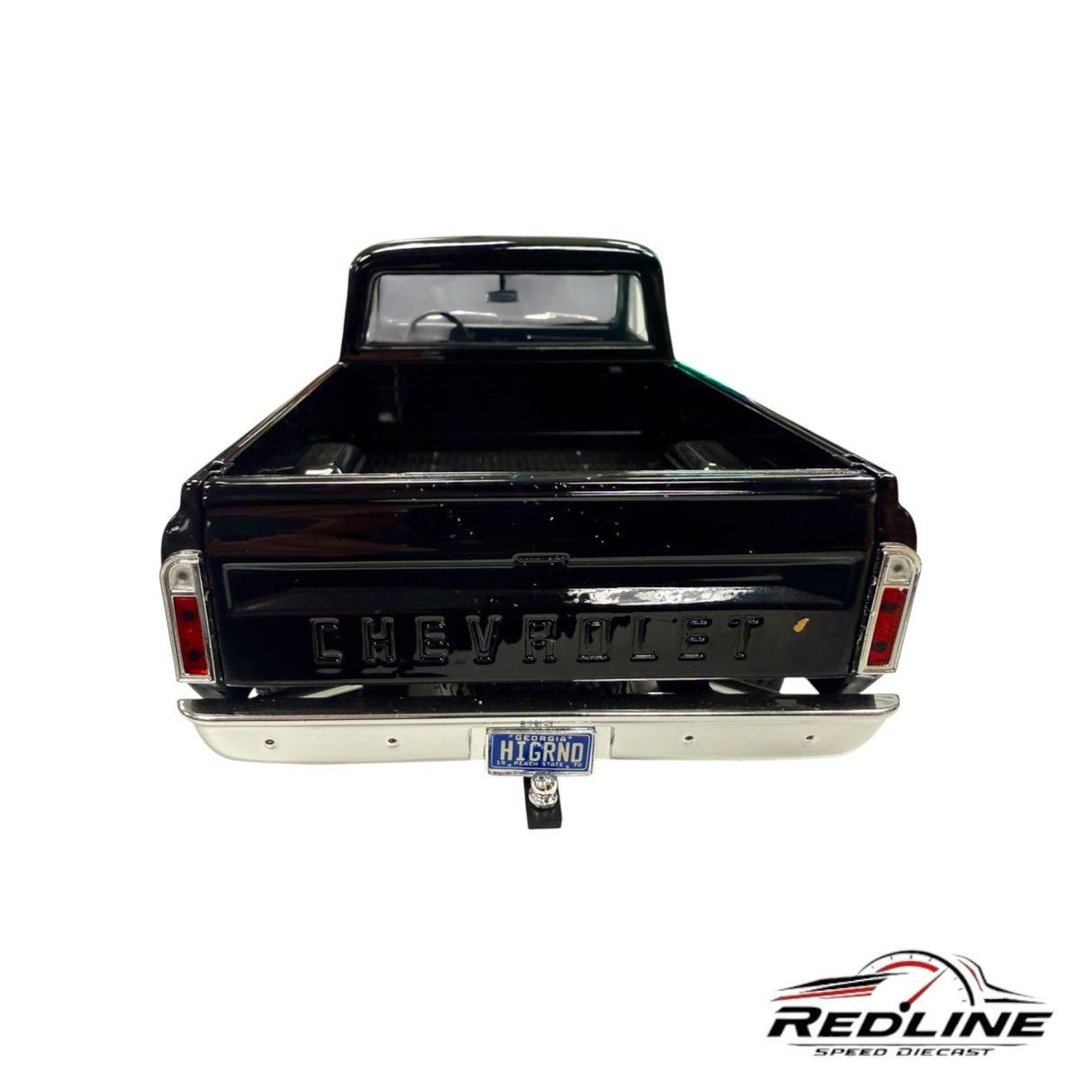 Rear view of a Redline Speed Diecast 1970 Chevrolet K-10 pickup model in glossy black with chrome bumper