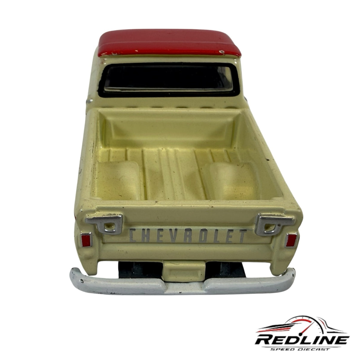 Redline Speed Diecast vintage Chevrolet pickup truck model in cream and red, rear view showing tailgate detail.
