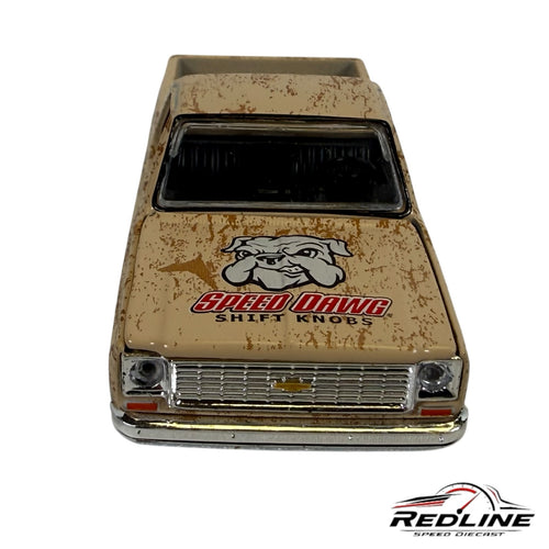 Redline Speed Diecast 1973 Chevrolet pickup truck model with a weathered tan finish and Speed Dawg bulldog hood graphic