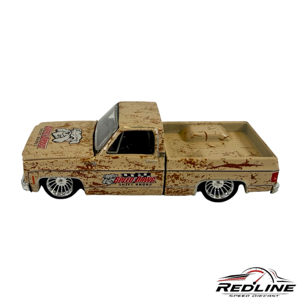 Redline Speed Diecast 1973 Chevrolet pickup model in weathered tan with Speed Dawg branding and chrome wheels