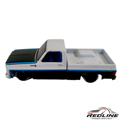 Redline Speed Diecast 1979 Chevrolet Scottsdale pickup truck model in white and black with blue racing stripes
