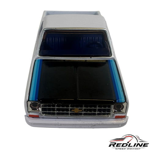 Redline Speed Diecast 1979 Chevrolet Scottsdale model truck in white and black with blue racing stripes, front view.