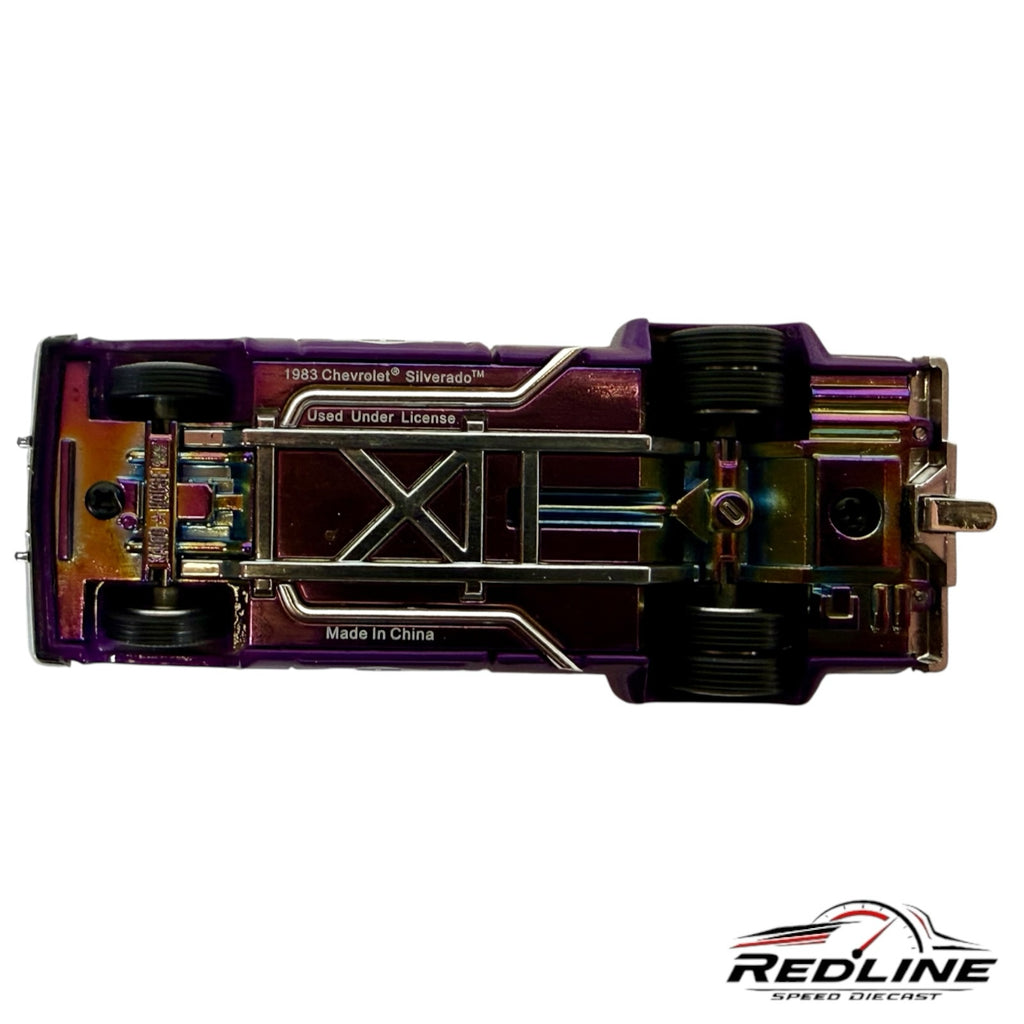Underside view of a Redline Speed Diecast 1983 Chevrolet Silverado Dually model showing the metallic purple chassis