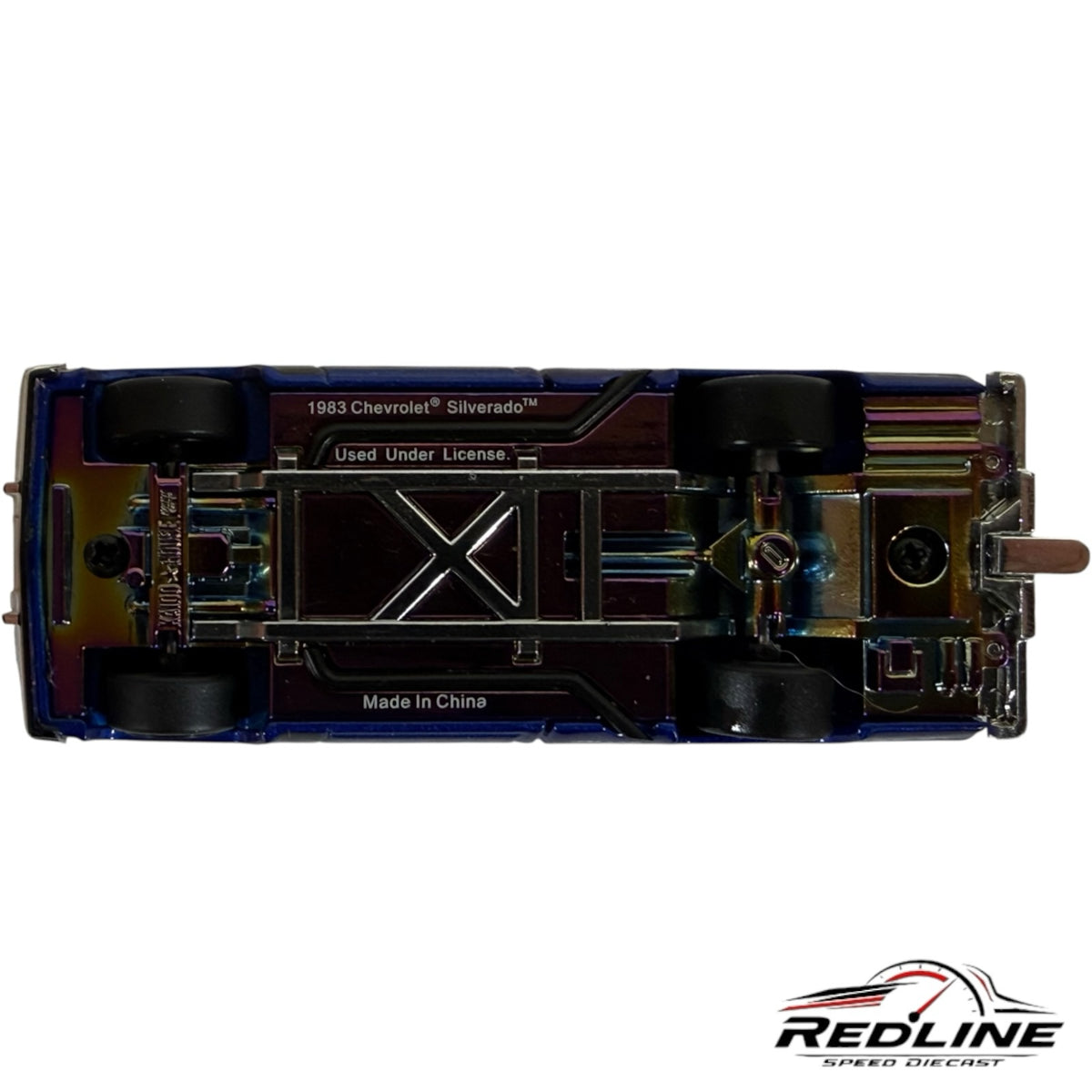 Underside view of Redline Speed Diecast 1983 Chevrolet Silverado model truck showing metallic chassis and wheels