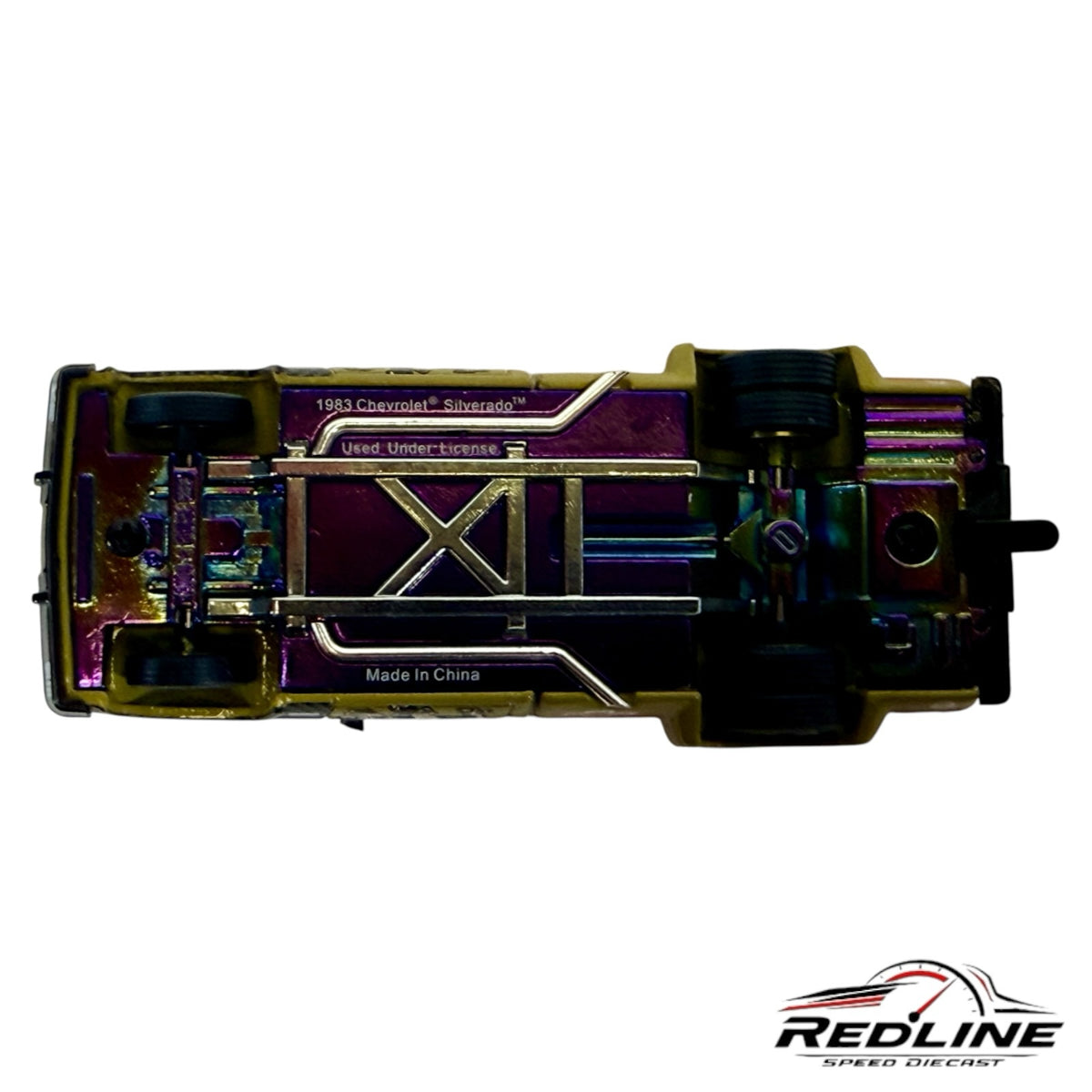 Underside view of Redline Speed Diecast 1983 Chevrolet Silverado showing the iridescent chassis and exhaust detail.