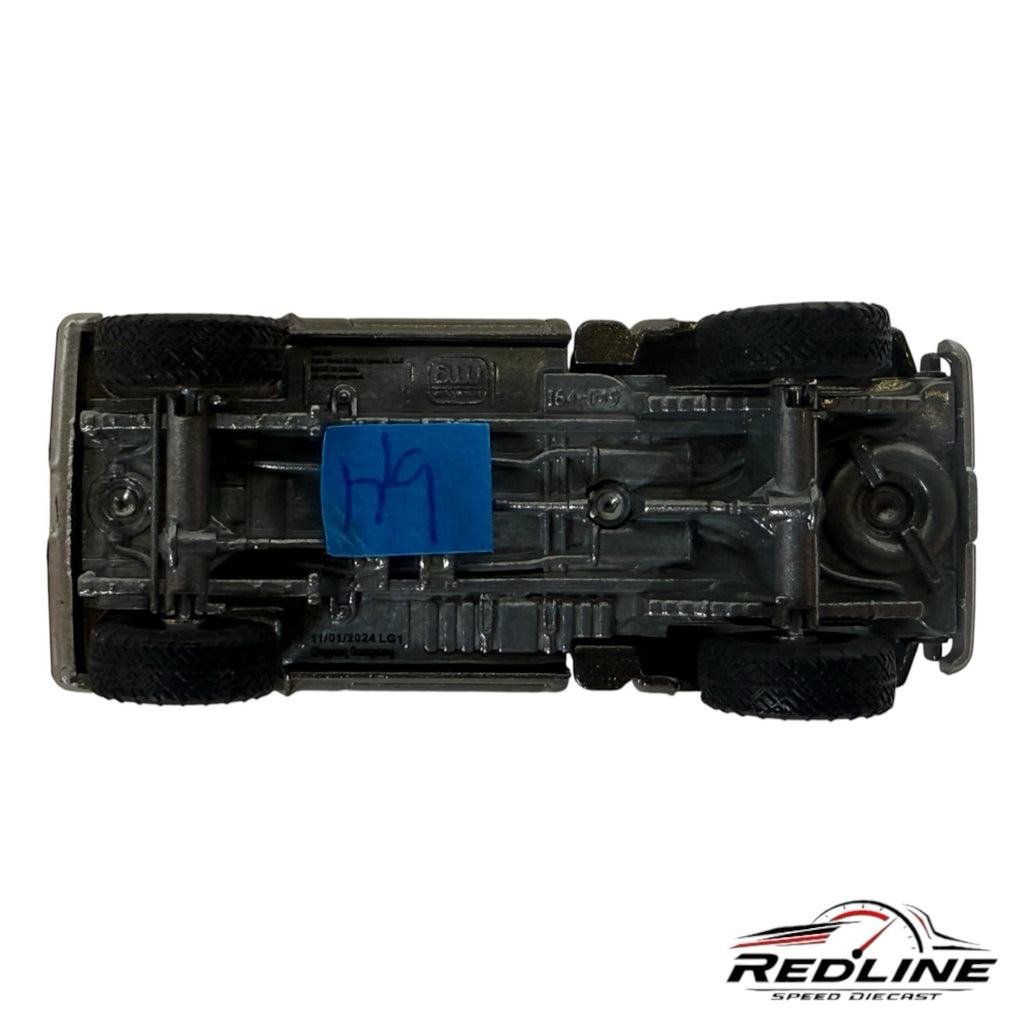 Underside view of a Redline Speed Diecast Chevrolet Silverado 1:64 scale model showing the metal chassis and tires