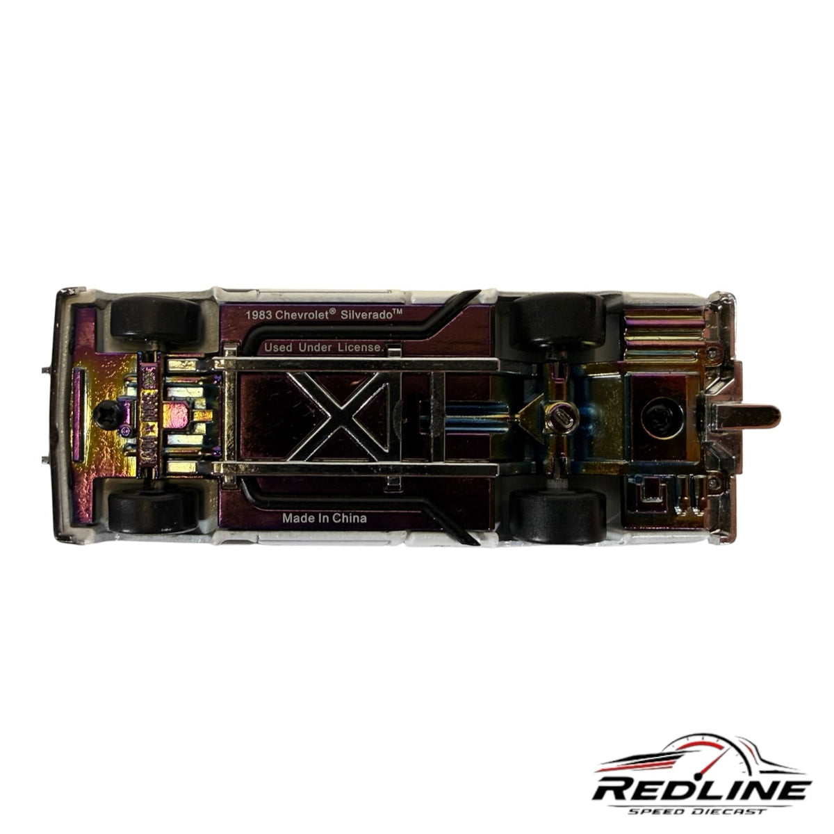 Underside view of a Redline Speed Diecast KAIDO HOUSE Chevrolet Silverado 1:64 scale model with iridescent chassis
