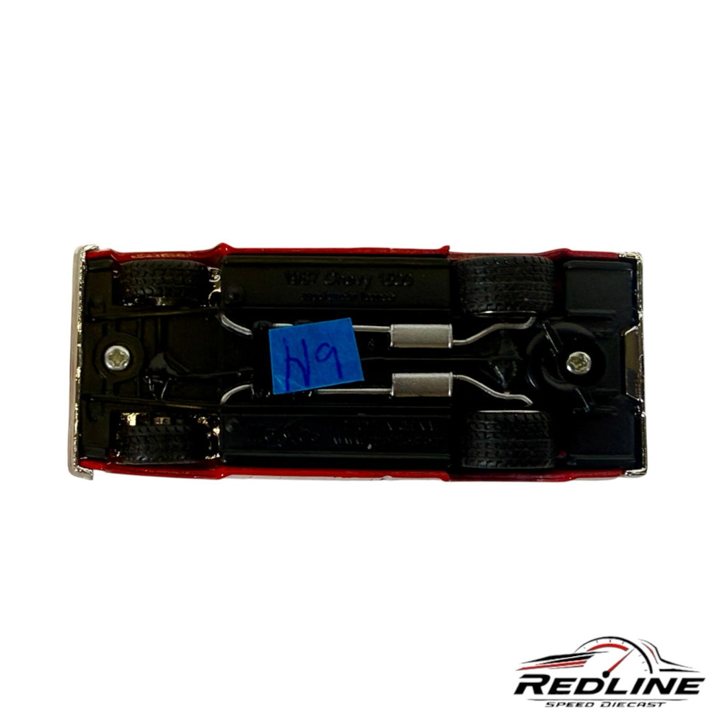 Underside view of a Redline Speed Diecast 1987 Chevrolet Silverado model truck showing chassis and exhaust details.