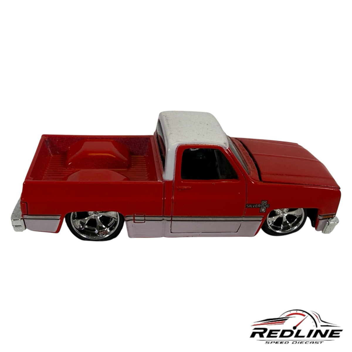 Redline Speed Diecast 1987 Chevrolet Silverado truck model in red and white with chrome wheels and lowered stance