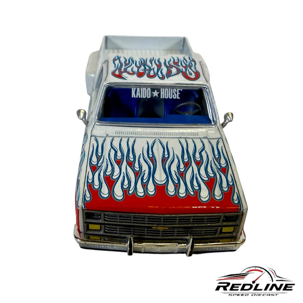 Redline Speed Diecast 1:64 scale Chevrolet Silverado Dually model with white paint and red and blue flame graphics.