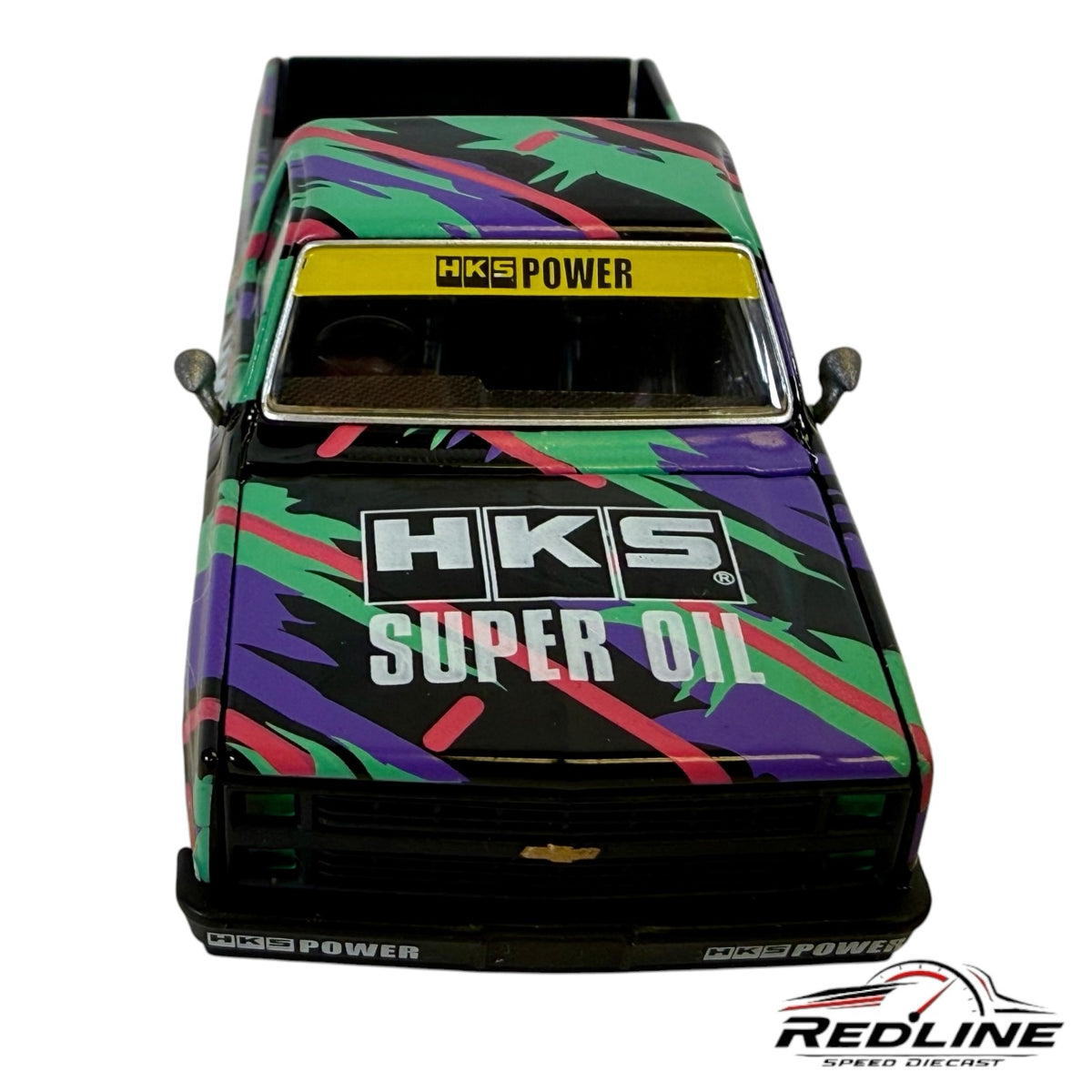 Redline Speed Diecast 1:64 scale 1983 Chevrolet Silverado HKS model truck with black base and colorful racing livery.