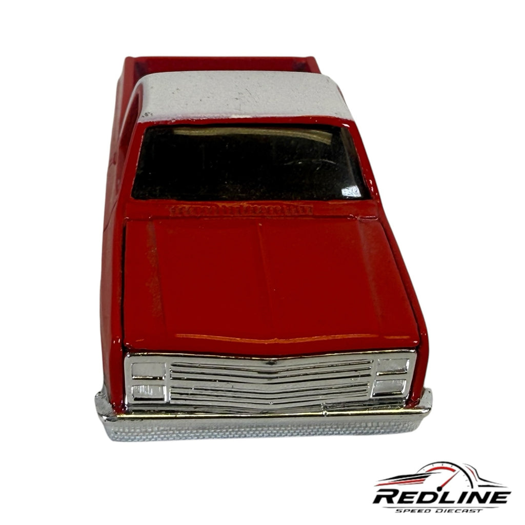 Redline Speed Diecast 1987 Chevrolet Silverado model truck in red and white with a chrome grille and front bumper.