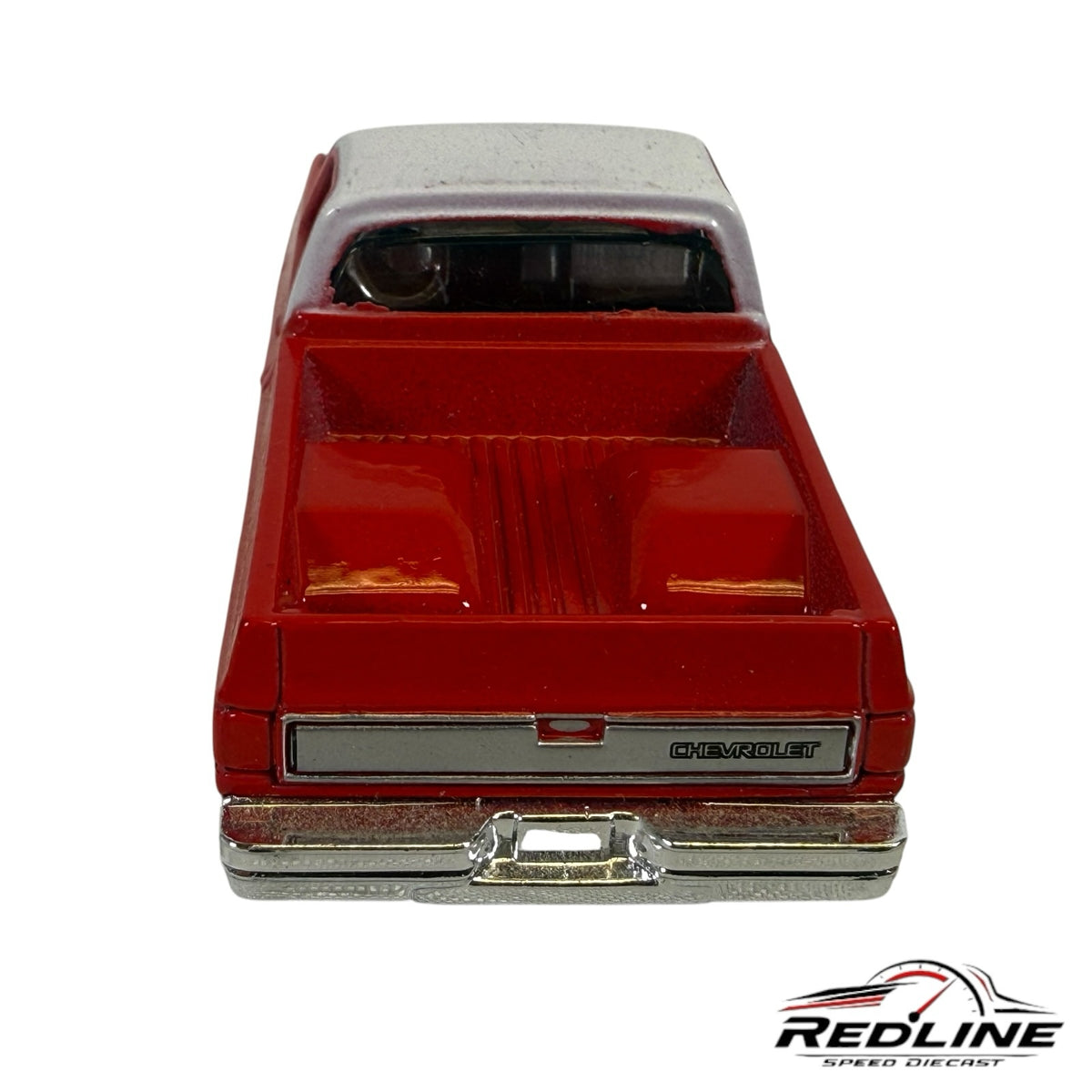Redline Speed Diecast 1987 Chevrolet Silverado model truck in red and white with a chrome rear bumper and tailgate