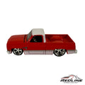 Redline Speed Diecast 1987 Chevrolet Silverado model truck in red and white with chrome wheels and detailed bed.