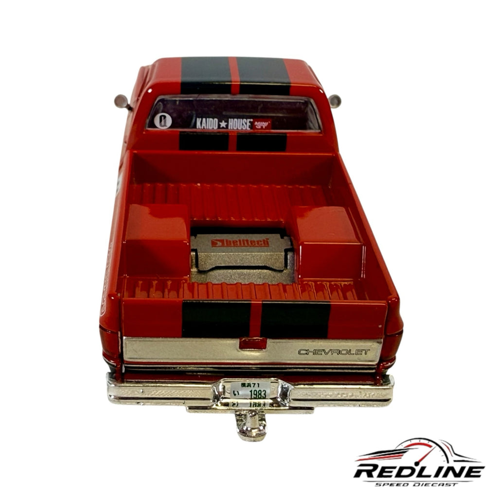 Redline Speed Diecast 1983 Chevrolet Silverado model truck in red and black with detailed truck bed and chrome bumper