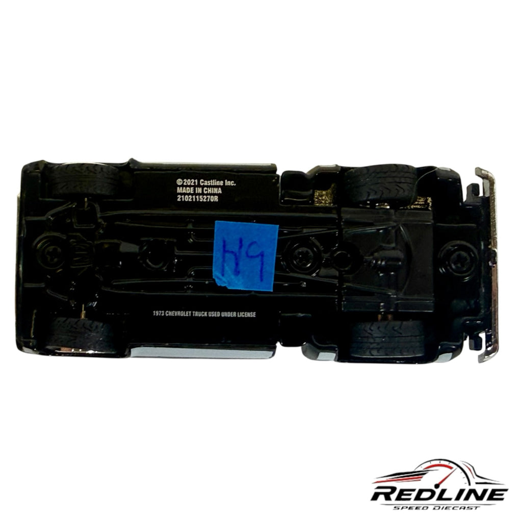 Underside view of a Redline Speed Diecast 1973 Chevrolet Cheyenne 10 model truck showing chassis and wheel detail.