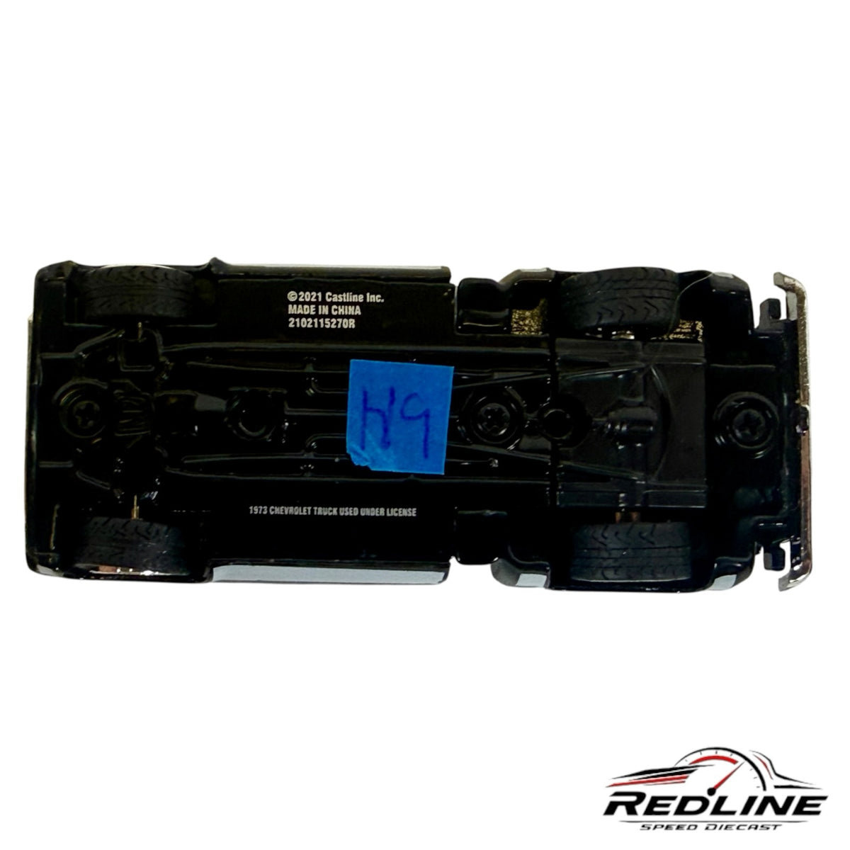 Underside view of a Redline Speed Diecast 1973 Chevrolet Cheyenne 10 model truck showing chassis and wheel detail.
