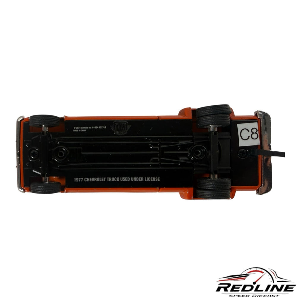 Underside view of a Redline Speed Diecast 1977 Chevrolet C30 dually pickup truck model showing chassis details