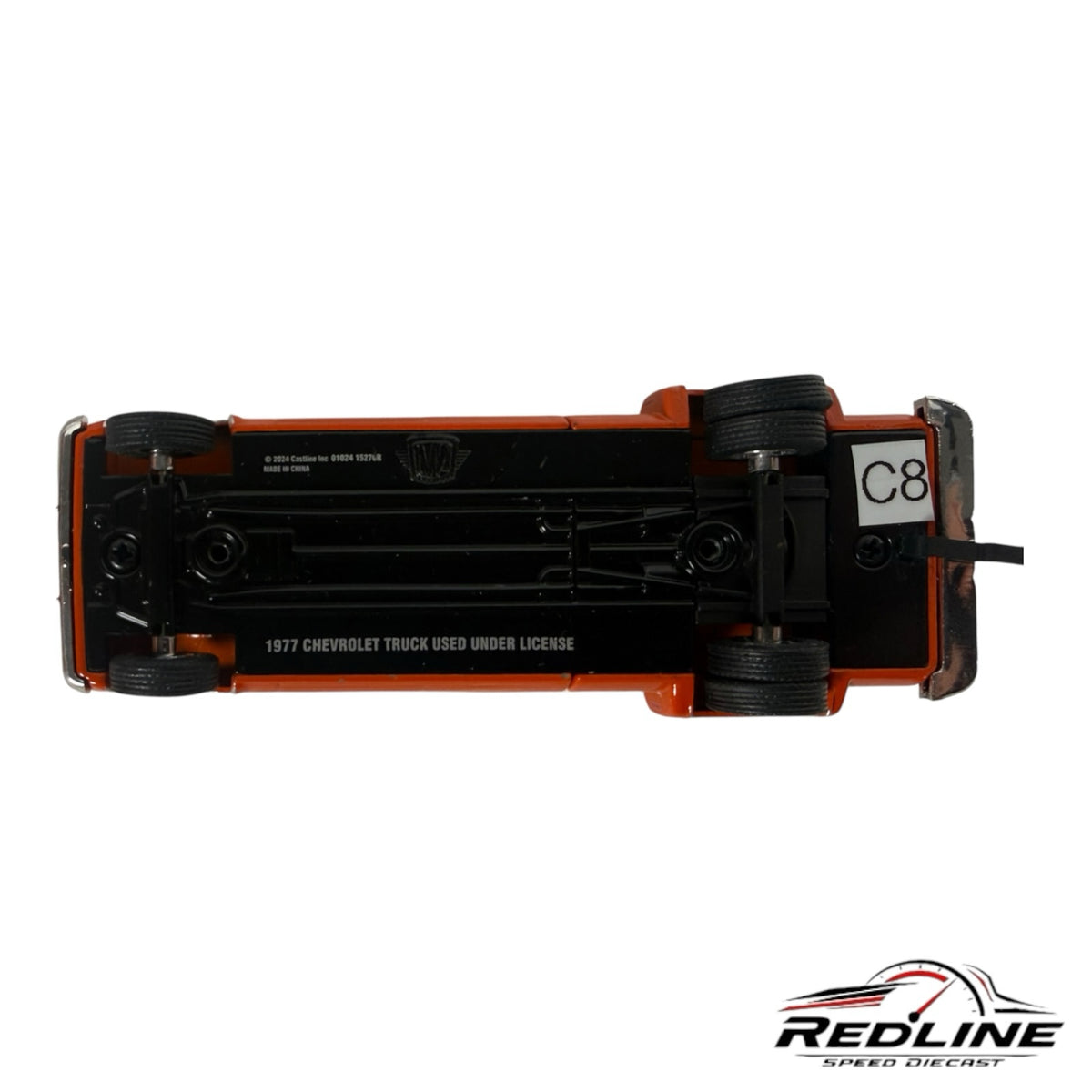 Underside view of a Redline Speed Diecast 1977 Chevrolet C30 dually pickup truck model showing chassis details