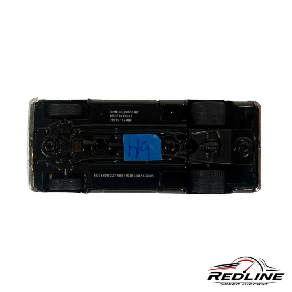 Underside view of a Redline Speed Diecast 1974 Chevrolet C10 pickup truck model showing chassis details