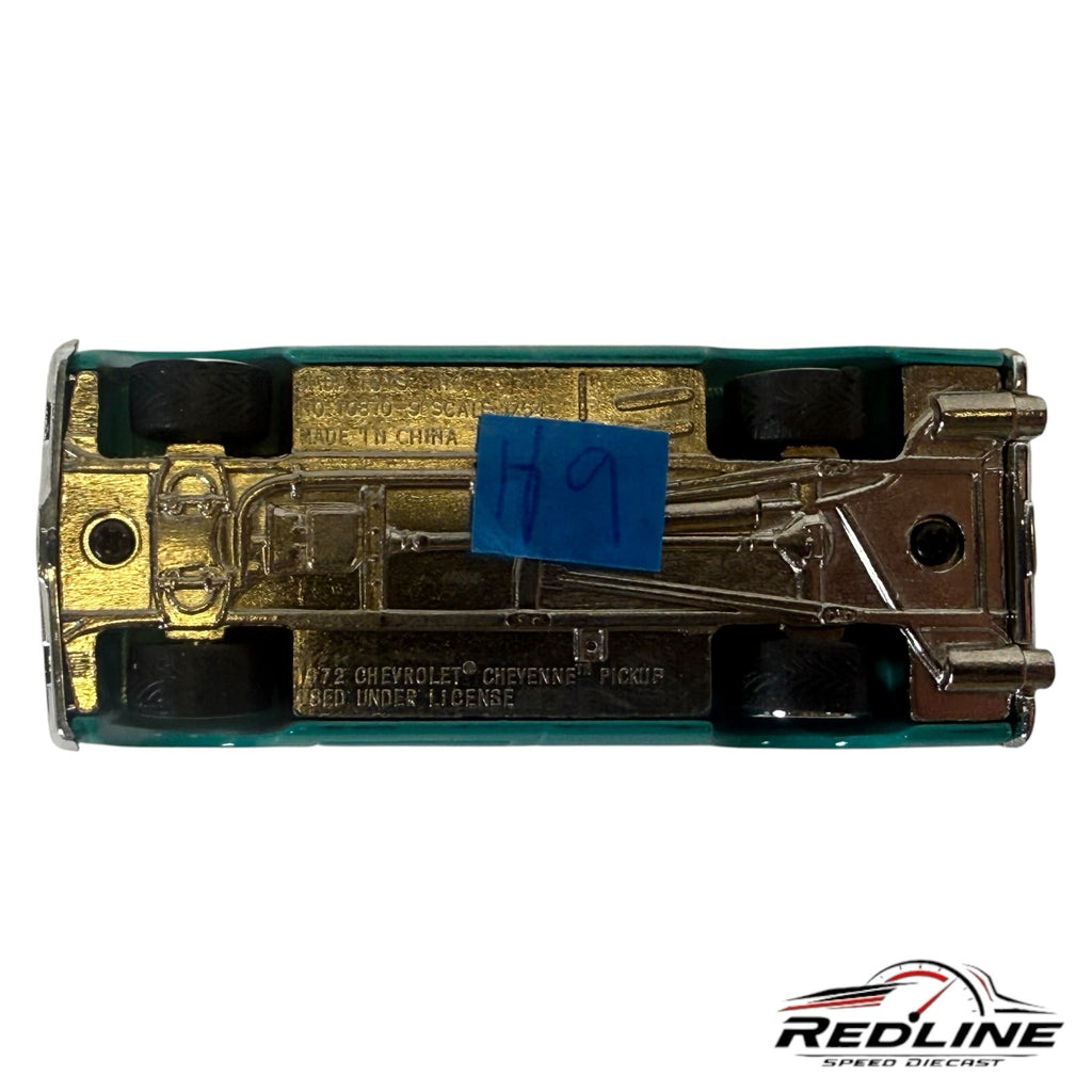 Underside view of a Redline Speed Diecast 1972 Chevrolet Cheyenne pickup model showing chassis and wheel details